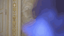 a woman is sitting in a bathtub with a blue light coming out of it