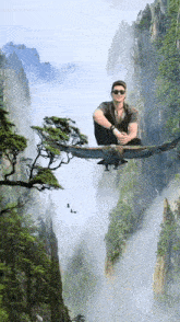 a man is sitting on an eagle flying over a mountain range