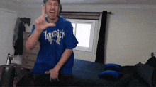 a man wearing a blue t-shirt that says hoodrich