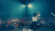 a girl in a sailor uniform is dancing on a stage
