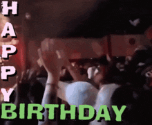 a group of people raising their hands in the air with the words happy birthday written in green