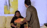a man is holding a tray in front of a woman .