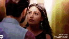a man and a woman are looking at each other in a video that was made with vivavideo .