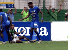 a soccer player in a blue jersey with the number 8 on the back