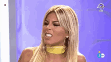 a woman is making a funny face in front of a screen that says wall