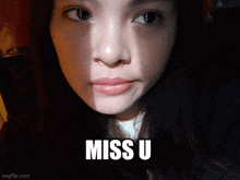 a close up of a woman 's face with the words miss u below her