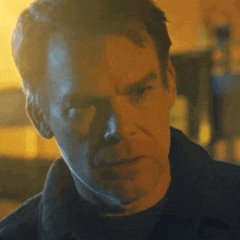 a close up of a man 's face with a shadow on his face