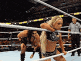 a woman in a wrestling ring with the letter d on her top