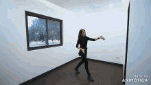 a woman standing in an empty room with the words made in animatica on the bottom