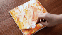 a person is painting a picture on a canvas with a spatula .