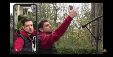 a man is taking a selfie with a microphone in front of him