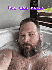 a man with a beard is taking a bath with the words how you doin written above him