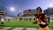 a football player wearing a maroon jersey with the number 8 on the front