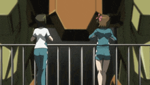 two girls standing on a balcony looking at a giant robot