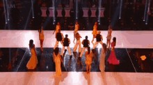 a group of people are dancing on a stage and the words live are on the bottom