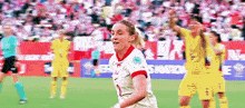 a female soccer player wearing a white jersey with the number 9 on it