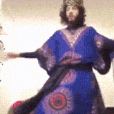 a man with a beard wearing a blue dress