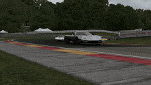 a race car is driving down a track with a yamaha sign behind it