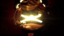 a close up of a person 's face with a glowing light coming out of it