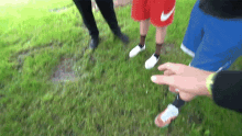a person wearing a pair of nike shorts stands in the grass