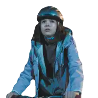 a woman wearing a helmet and a blue jacket looks at the camera