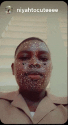 a man with glitter on his face and the name niyahtocuteee
