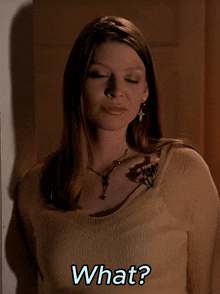 a woman wearing a necklace and earrings is asking the question what