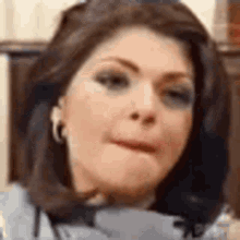 a close up of a woman making a funny face