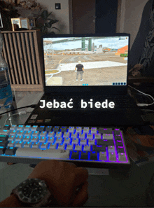 a person playing a video game on a laptop that says jebac biede on it