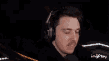 a man wearing headphones is making a funny face .