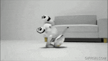 a black and white gif from gifrun.com shows a stuffed animal running on the floor
