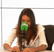 a woman sitting in front of a microphone with the word dial on it