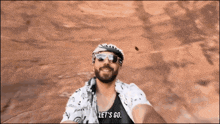 a man taking a selfie with the words let 's go