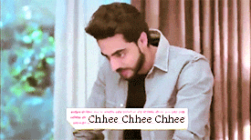 a man with a beard is sitting in front of a window with a sticker that says chhee chhee chhee on it