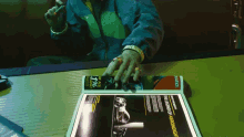a person sitting at a table with a magazine open to a page that says the legend of aeronight