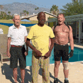 three men are posing for a picture in front of a swimming pool