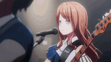 a girl is singing into a microphone while holding a bass guitar that says esp on it