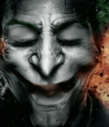 a close up of the face of a joker with his eyes closed