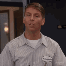 a man wearing a striped shirt with a patch that says maintenance