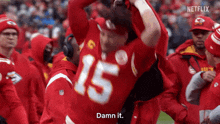 a man in a red jersey with the number 15 on it