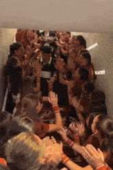 a group of people in a hallway with the word lacoste written on the wall
