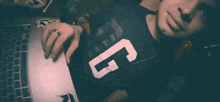 a young man wearing a black shirt with the number 5 on it