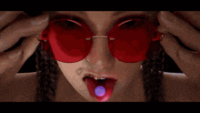 a close up of a pair of glasses with a purple background