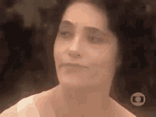 a close up of a woman 's face with a blurry background .