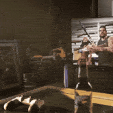 a bottle of whiskey sits on a table in front of a tv screen that says advertising