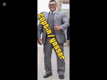 a man in a suit is holding a gun in front of arabic writing