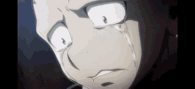 a close up of a man 's face with tears coming out of his eyes