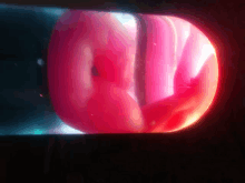 a close up of a red object with a glowing center