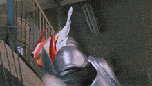 a person in a silver and red costume is walking down a set of stairs