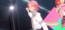 a man with pink hair is standing in front of a pink square